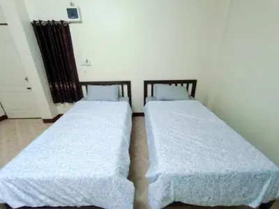 two beds sitting next to each other in a room at ธิติกาญจน์ อพาร์ทเม้นท์ in Ban Khlong Samrong