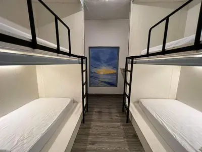 a hallway with three bunk beds in a room at Comfy Crib Hostel in Bangkok