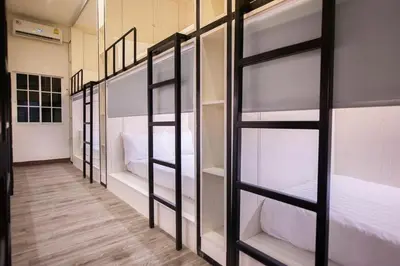 a room with four bunk beds in it at Comfy Crib Hostel in Bangkok