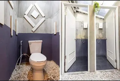a bathroom with a toilet and a walk in shower at Comfy Crib Hostel in Bangkok