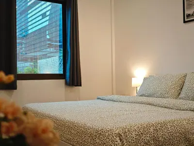 a bedroom with a bed and a window with a view at homey stay and cafe by hematoa in Bangkok