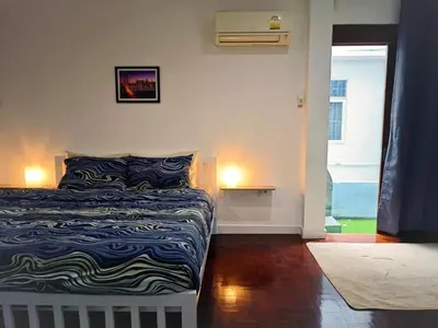 a bedroom with a bed with a blue and white blanket at homey stay and cafe by hematoa in Bangkok