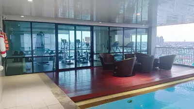 a gym with a swimming pool in a building at KnightsBridge BTS Bearing in Ban Khlong Samrong