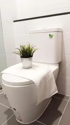 a white toilet with a plant on top of it at KnightsBridge BTS Bearing in Ban Khlong Samrong