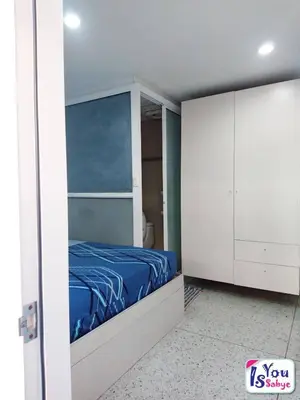 a bedroom with a blue bed and white cabinets at IsYou Sabye ห้องพักรายวัน รามคำแหง in Ban Zong Katiam