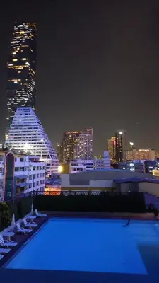 a view of a city skyline at night at Silom Cityview Paradise Room in Bang Rak