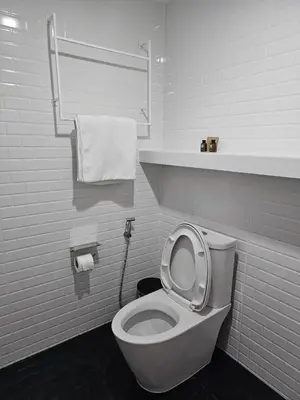 a bathroom with a toilet with the lid up at โรงแรมแอเรียเพลส สาทร (AREA Place) in Chong Nonsi