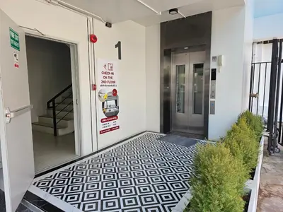 an entrance to a building with a black and white floor at โรงแรมแอเรียเพลส สาทร (AREA Place) in Chong Nonsi
