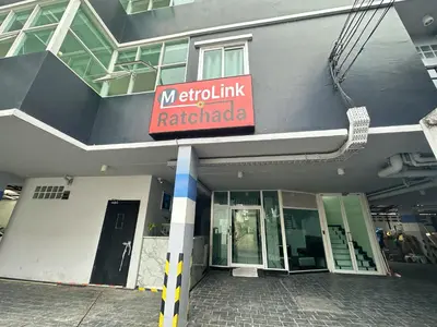 a building with a sign on the side of it at Metro Link Ratchada Hotel in Bangkok