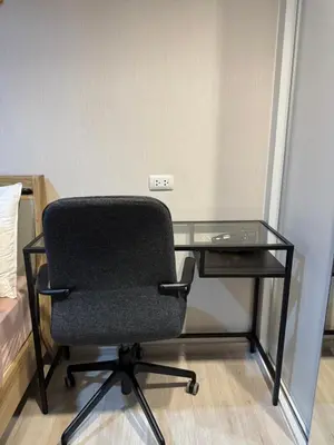 a desk with a black chair and a glass table at Near central westgate at bangyai 80 in Ban Bang Krabu