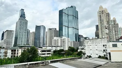 a city skyline with tall skyscrapers at The Tangerine Guesthouse in Bangkok