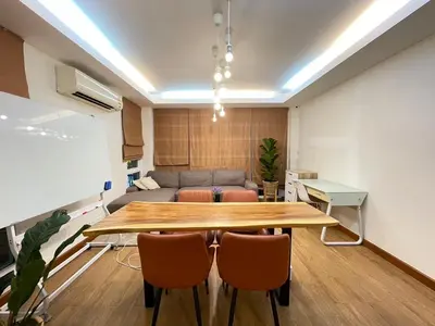 a conference room with a table and chairs and a couch at Modern 5-Bedroom Townhome near MRT and Local Charm in Bangkok