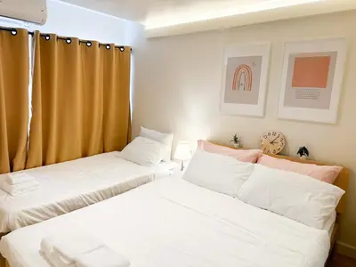 two beds sitting next to each other in a bedroom at Happiness sleep C3 in Ban Bang Phang