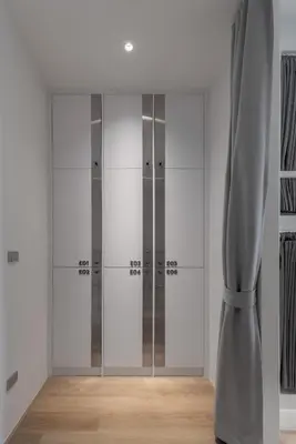 a dressing room with glass doors and a curtain at Matini Hostel grandstation in Bangkok