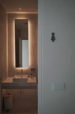 a bathroom with a sink and a mirror at Matini Hostel grandstation in Bangkok
