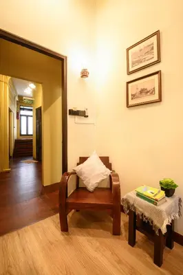 a living room with a chair and a table at Niras Bankoc Hostel in Bangkok