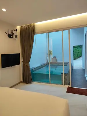 a bedroom with a large window with a swimming pool at KVILLA in Ban Khlong Bang Chak