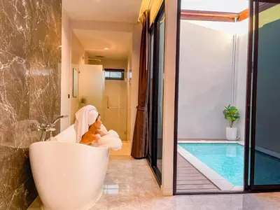 a bathroom with a tub with a teddy bear in it at KVILLA in Ban Khlong Bang Chak