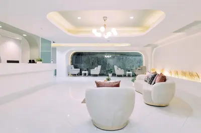 a living room with white furniture and a salon at Tori crown hotel in Bangkok