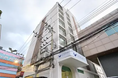 a building with a sign in front of it at Tori crown hotel in Bangkok