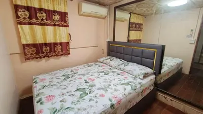 a small bedroom with a bed and a mirror at Rhythm of life guesthouse 56 in Bangkok