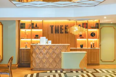 a store with a chandelier and a counter at THEE Bangkok by TH District in Bangkok