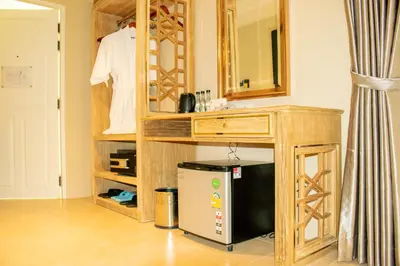 a bathroom with a wooden vanity with a sink and a mirror at Siri Grand Bangkok Hotel in Bangkok
