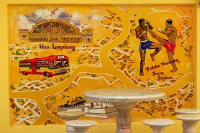 a wall with a mural of a city and a bus at Siri Grand Bangkok Hotel in Bangkok