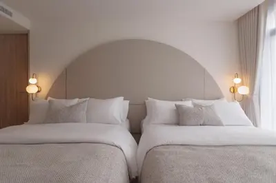 two beds sitting next to each other in a bedroom at CORRIDOR 2407 in Bangkok