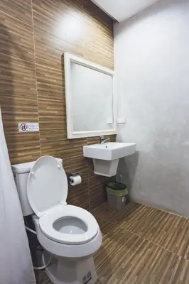 a bathroom with a toilet and a sink at Nitichai Place, Private Sukhumvit Townhome 8PAX in Bangkok