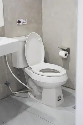 a bathroom with a white toilet and a sink at Nitichai Place, Private Sukhumvit Townhome 8PAX in Bangkok