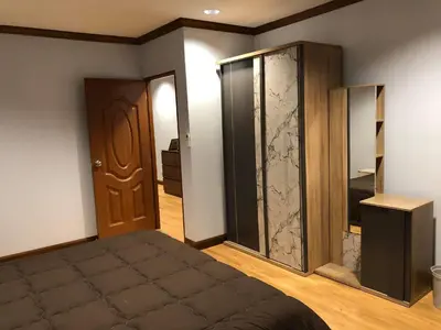 a bedroom with a bed and a sliding glass door at Private rooms in Phatumwan Chula near Samyan, Chinatown, Jay-o Siam center, Central world middle of Bangkok in Bangkok