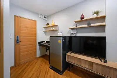 a living room with a large flat screen tv at You Hotel in Ban Zong Katiam