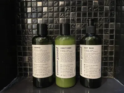 three bottles of soap sitting on a shelf at Luxurious Downtown condo w/train access in Bangkok