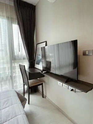 a bedroom with a large flat screen tv on a wall at Luxurious Downtown condo w/train access in Bangkok
