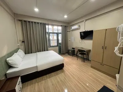 a bedroom with a bed and a desk in it at Bangwa House - MRT Bangwa Station in Bangkok
