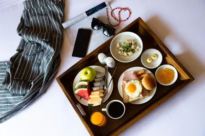 a tray of breakfast food with eggs and fruit at Jazzotel Bangkok in Bangkok