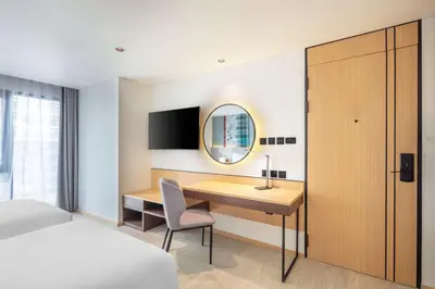 a bedroom with a desk and a bed and a mirror at Best Western Click Sathorn 11 Bangkok in Bangkok