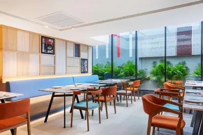 a restaurant with tables and chairs and large windows at Best Western Click Sathorn 11 Bangkok in Bangkok