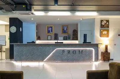 a lobby with a sign that says proctor at Prom Hotel in Bangkok