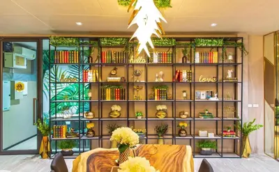 a room with a book shelf filled with books at Resort Style Room Suksawat 64 Bangkok ND in Ban Tha Hin