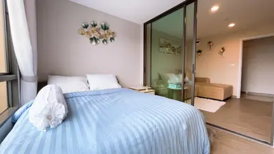 a bedroom with a blue bed and a mirror at Resort Style Room Suksawat 64 Bangkok ND in Ban Tha Hin