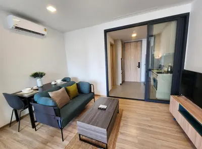 a living room with a couch and a table at Thanon Phaya in Bangkok