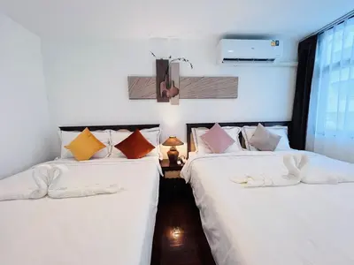 two beds in a room next to a window at \u5e02\u4e2d\u5fc3Ruam\u7cbe\u54c1\u522b\u5885 in Bang Kapi