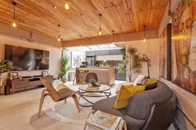 a living room with a couch and a table at Chic loft in Bangkok