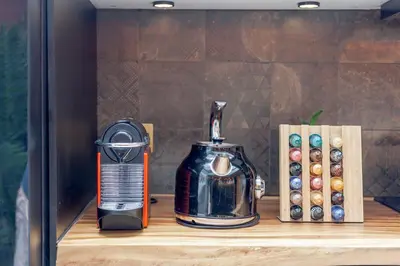 a coffee maker on a shelf next to dominoes at Chic loft in Bangkok
