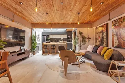 a living room with a couch and a table at Chic loft in Bangkok