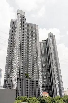 two tall buildings with trees in front of them at 1 BR plus@42th FL /2-3 min walk to BTS MRT Ladprao in Bangkok