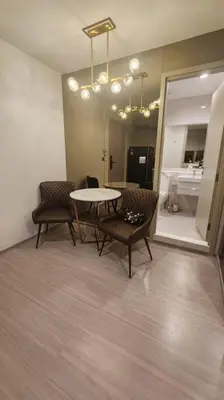 a room with a table and chairs and a bathroom at 1 BR plus@42th FL /2-3 min walk to BTS MRT Ladprao in Bangkok