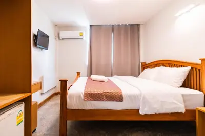 a bedroom with a bed and a television in a room at XX GO INN Khaosan Road Bangkok - โกอินน์ ถนนข้าวสาร กรุงเทพฯ in Bangkok
